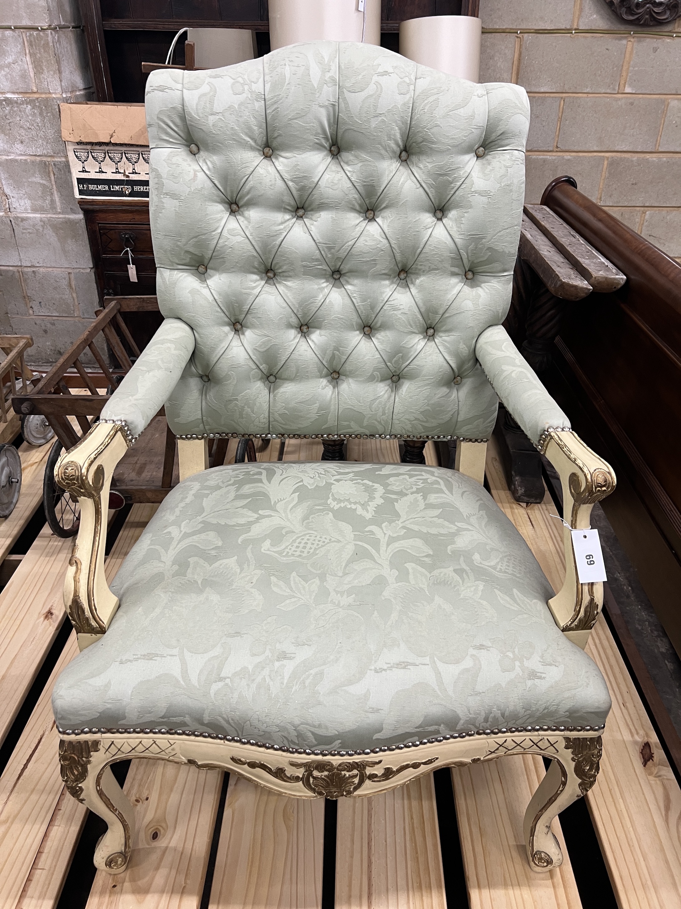 A Louis XVI style painted parcel gilt open armchair with buttoned green upholstery, width 72cm, depth 58cm, height 116cm